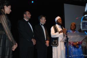 Imam Muhammad Ashafa addresses guests at the gala dinner in Geneva.  From left to right:  Mistress of Ceremonies Gabriella Wright, Imad Karam, Alan Channer, Imam Muhammad Ashafa and Pastor James Wuye